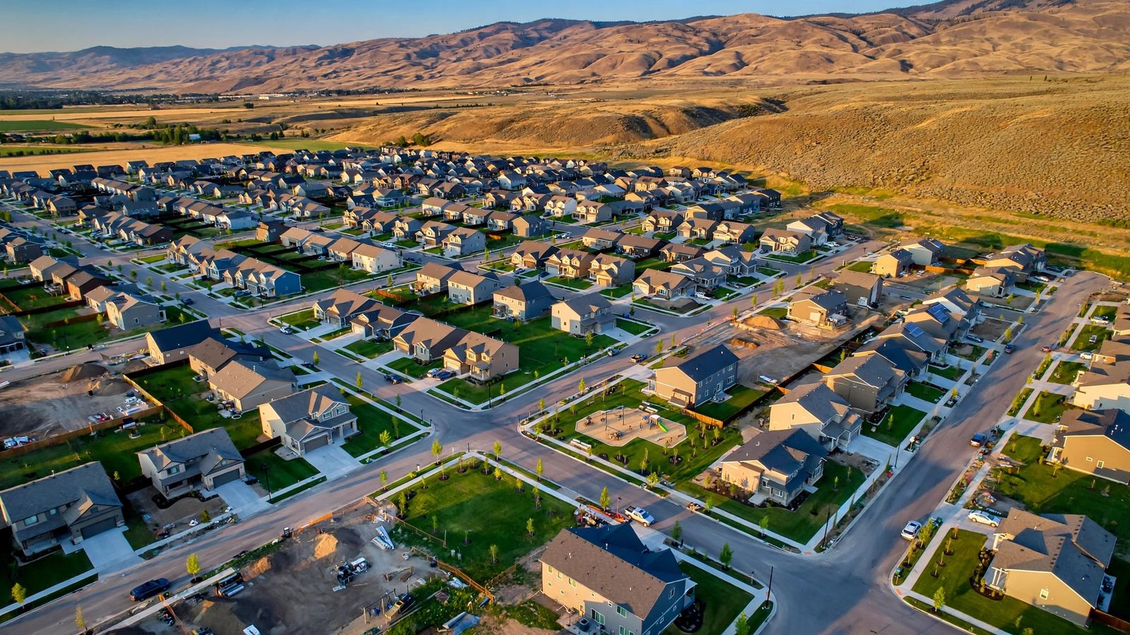 Aerial view of a newer suburban neighborhood in Meridian, Idaho with foothills in the distance